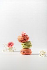 Different types of macaroons on a white background. Pink and green macaroons.