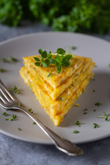 Tortilla, Spanish omelette made with eggs and potatoes. Traditional Spanish tapas or snack served with mini basil.