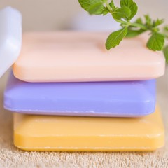 three bars of soap on a towel