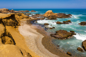 Aerial view of a rocky beach and cliff in Huarmey in Summer,  Ancash, Peru