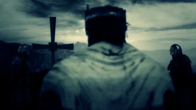Medieval King Standing In front of a Big Cross and Praying
