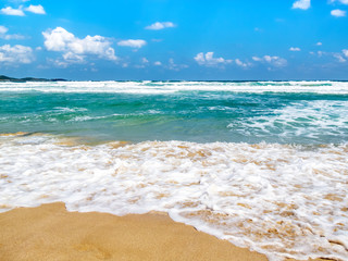 Fototapeta na wymiar Waves spreading on a sandy Bulgarian Black Sea Coast beach at the seaside resort of Primorsko