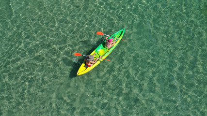 Aerial drone photo of 2 women practising canoe in open ocean tropical exotic sea