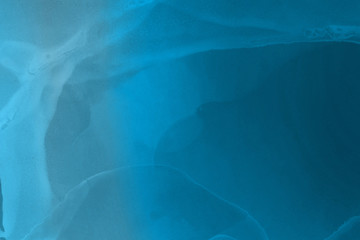Hand painted blue alcohol ink background. Abstract delicate winter season texture. Contemporary wallpaper. 