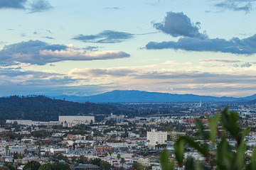 city scape from hilltop overlooking valley, of business, homes and streets flowing into san...