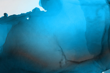 Hand painted blue alcohol ink background. Abstract delicate winter season texture. Contemporary wallpaper. 