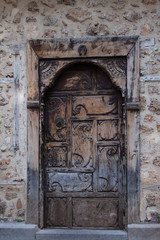 Fototapeta na wymiar Streets of Turkey, old wooden doors, carved doors in the stone wall