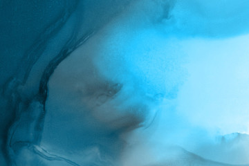 Hand painted blue alcohol ink background. Abstract delicate winter season texture. Contemporary wallpaper. 