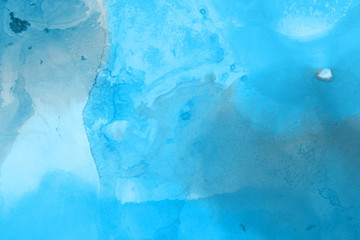 Hand painted blue alcohol ink background. Abstract delicate winter season texture. Contemporary wallpaper. 