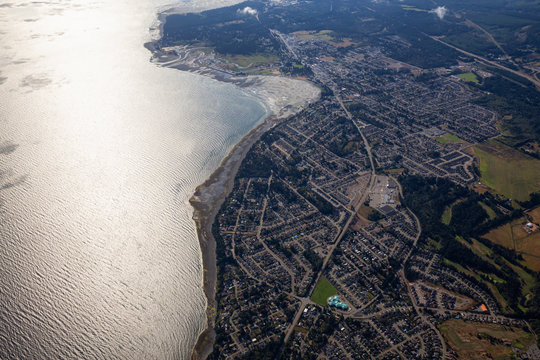 Aerial view of a small town, Parksville, on Vancouver Island during a sunny summer morning. Taken near Nanaimo, British Columbia, Canada.