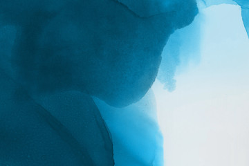 Hand painted blue alcohol ink background. Abstract delicate winter season texture. Contemporary wallpaper. 