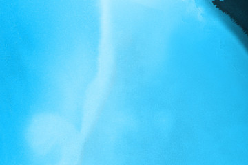 Hand painted blue alcohol ink background. Abstract delicate winter season texture. Contemporary wallpaper. 