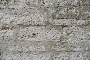 Cream and white old brick wall texture background. Brickwork or stonework flooring interior rock old pattern clean concrete grid uneven bricks design stack.