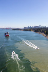 Obraz premium Aerial view of Stanley Park and Downtown City during a vibrant sunny day. Taken from Lions Gate Bridge, Vancouver, British Columbia, Canada.