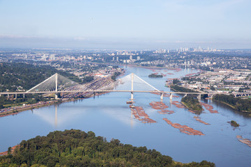 Aerial view of Fraser River and Port Mann Bridge during a vibrant summer morning. Taken in Greater Vancouver, British Columbia, Canada.