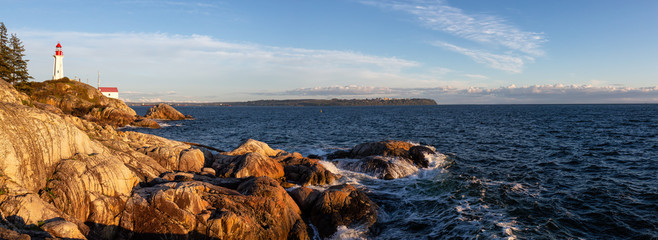 Beautiful Panoramic view of a rocky ocean coast during a vibrant sunny sunset. Taken in Lighthouse...