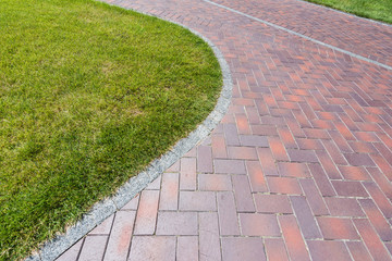 green and fresh grass near walkway in park