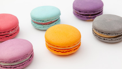 Fototapeta na wymiar Colorful macaroon on white surface. French cookies as a treat for the holiday