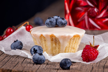 Muffin with berries^ blue berry, raspberry, red currant and glass of fruit compote