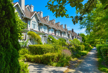 Residential townhouses on sunny day in Vancouver, British Columbia, Canada.