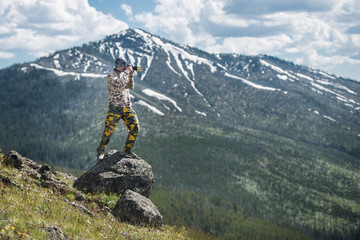 Professional photographer man taking photos and enjoy the view of mountains in Yellowstone National Park