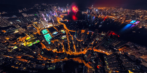 Panorama aerial view of Hong Kong City at night with fireworks