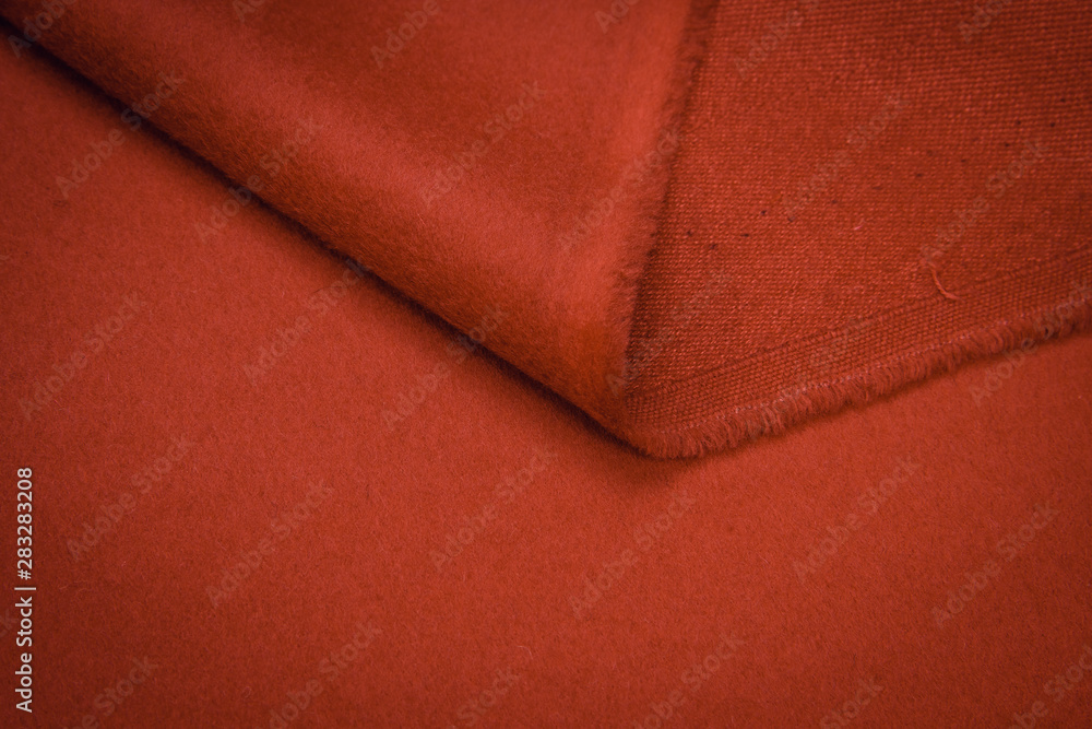 Wall mural fabric coat red. color texture of the coat fabric close-up.