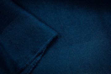 A blue cloth overcoat. Color texture of the coat fabric close-up.