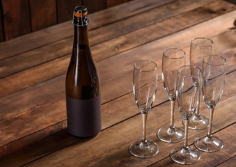 Christmas holiday table with glasses and a bottle of wine of champagne. Eve of new year,...