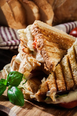 Stack of panini with ham, cheese and lettuce sandwich