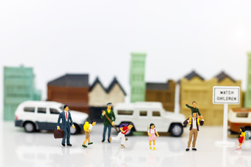 Miniature people: Parents and children in the city.