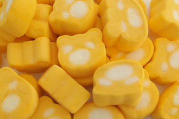 Yellow marshmallow candies as background