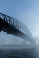 Fototapeta na wymiar Morning blue hour view of Sydney Harbour Bridge with some fog.