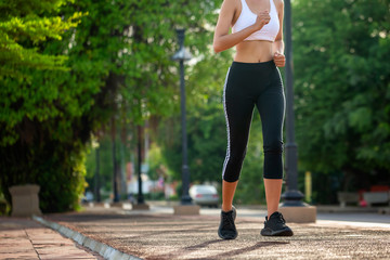 Beautiful woman jogger outdoor living healthy lifestyle in city park. Concept sport and a healthy...