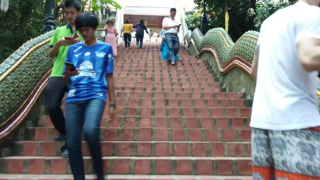 People walking on dragon stairs entrance in thai temple at Chiang mai,Thailand
