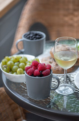 Served breakfast at sunny wooden summer terrace