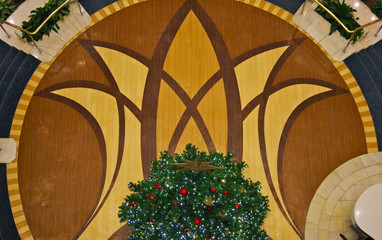 Festive Christmas X-Mas Xmas tree decoration for the holidays inside ship atrium lobby onboard...