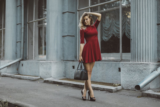 Premium Photo | Blonde girl dressed in a fashionable short dress poses  outdoors