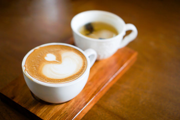 Heart-shaped coffee on a brown wood table