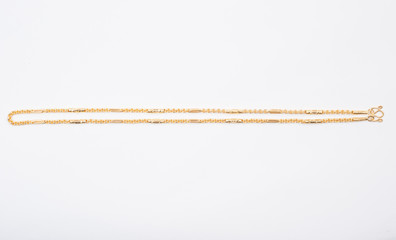 Gold chain necklace isolated on white background.