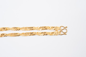 Gold chain necklace isolated on white background.