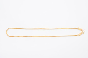 Gold chain necklace isolated on white background.