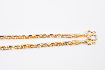 Gold chain necklace isolated on white background.