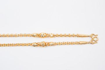 Gold chain necklace isolated on white background.