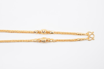 Gold chain necklace isolated on white background.