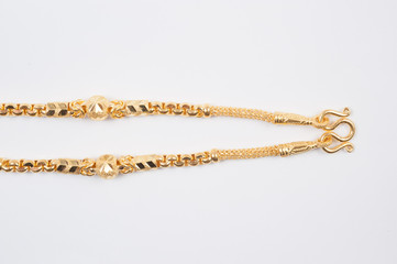 Gold chain necklace isolated on white background.