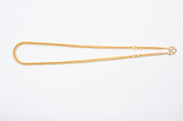 Gold chain necklace isolated on white background.