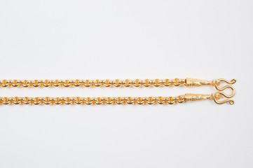 Gold chain necklace isolated on white background.