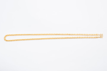 Gold chain necklace isolated on white background.