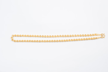 Gold chain necklace isolated on white background.